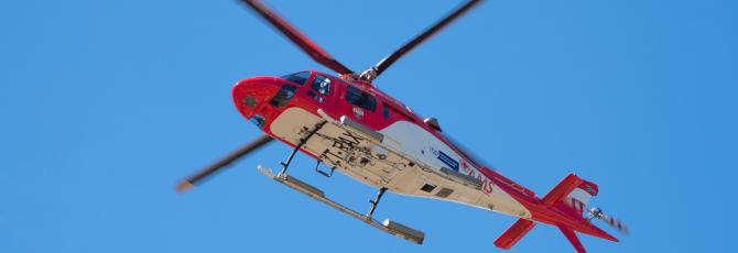 Red rescue helicopter in flight