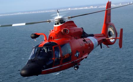 Red helicopter in flight